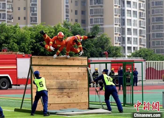 新消防員進(jìn)行消防障礙接力操展示。　劉忠俊 攝